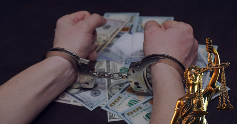 Hands placed on the table with handcuffs where money and drugs are also placed