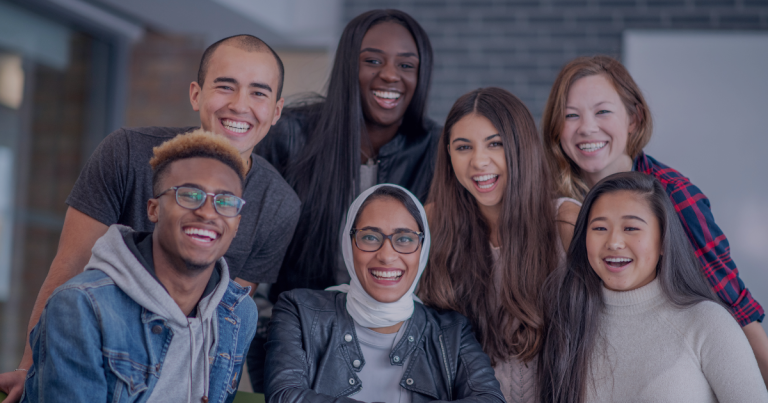 A group of multicultural people posing for a picture