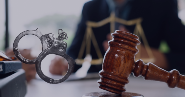 A criminal lawyer seated at the table where a gavel is placed on it